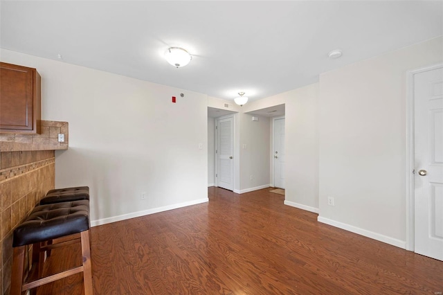 interior space featuring baseboards and wood finished floors