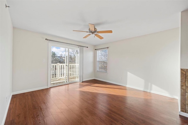 unfurnished room featuring wood finished floors, a ceiling fan, and baseboards