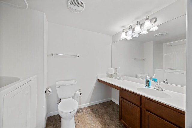 bathroom with toilet, visible vents, washer / clothes dryer, and vanity