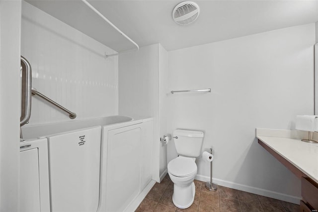 bathroom featuring baseboards, visible vents, toilet, tile patterned flooring, and vanity