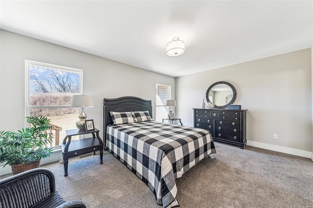 bedroom with multiple windows, carpet, and baseboards