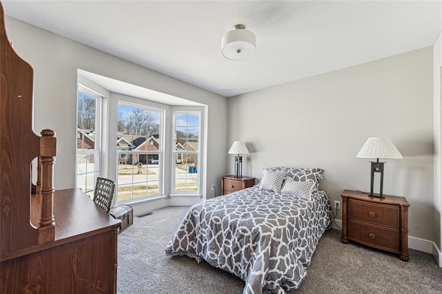 bedroom with carpet, visible vents, and baseboards