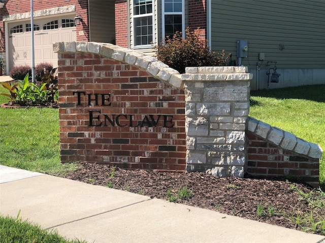 details featuring electric meter and brick siding