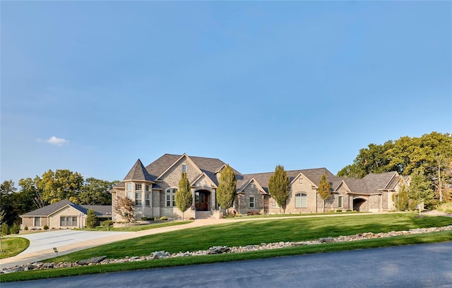 french country inspired facade featuring a front lawn