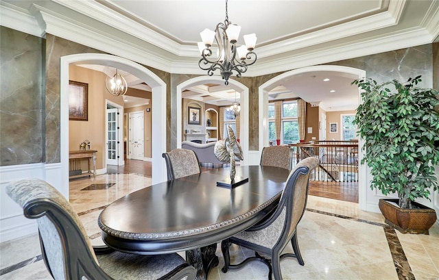 dining area with ornamental molding and a chandelier