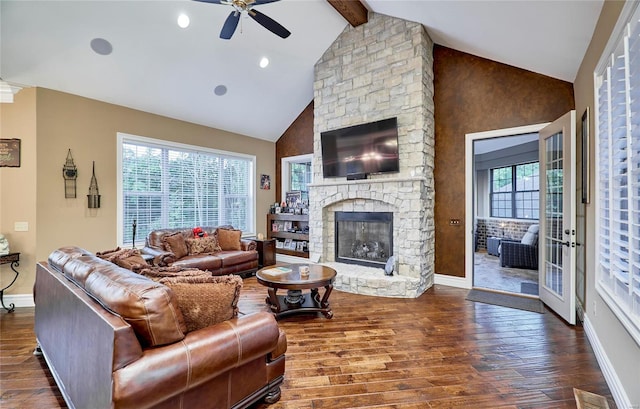 living room with beamed ceiling, a stone fireplace, dark wood-type flooring, and high vaulted ceiling