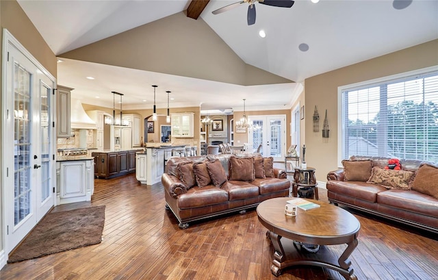 living room featuring beam ceiling, ceiling fan with notable chandelier, ornamental molding, and dark hardwood / wood-style floors