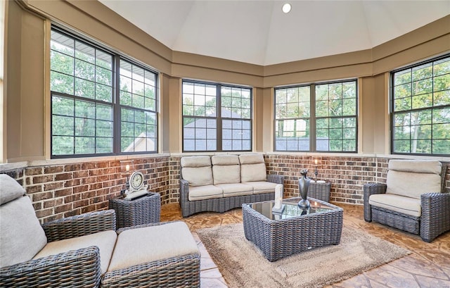 sunroom / solarium featuring plenty of natural light and lofted ceiling