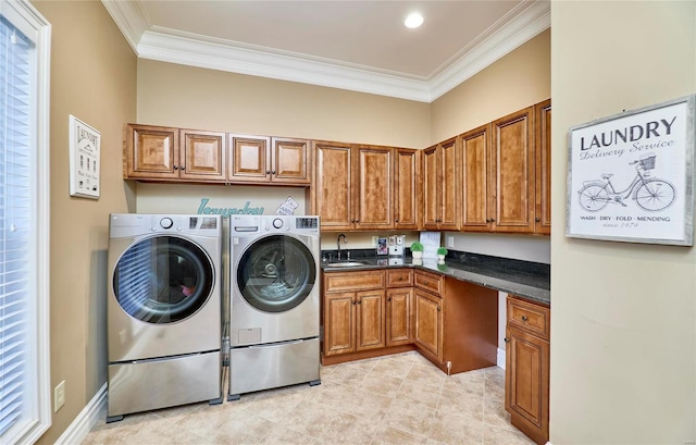 laundry area featuring separate washer and dryer, sink, crown molding, and cabinets