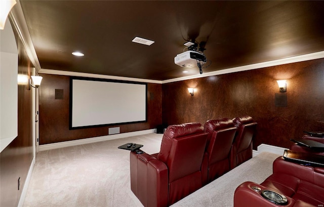 carpeted cinema with ceiling fan and ornamental molding