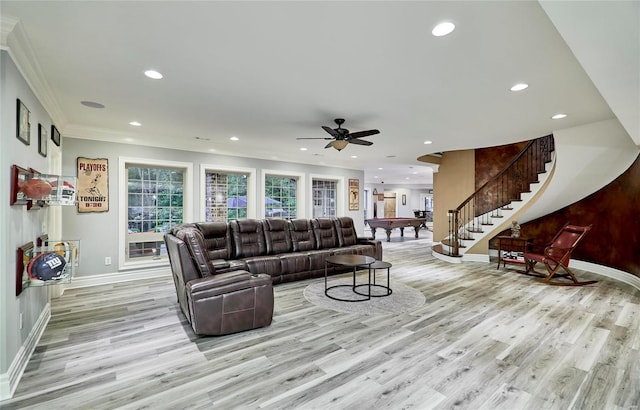 living room featuring crown molding, ceiling fan, and light hardwood / wood-style flooring