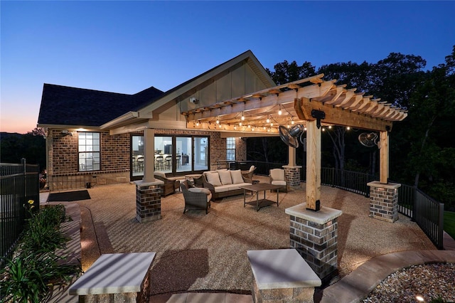 patio terrace at dusk with outdoor lounge area and a pergola