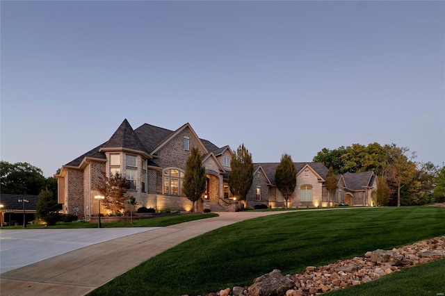 french country style house with a yard