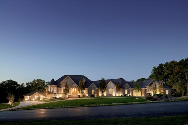 french provincial home featuring a lawn