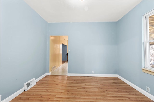 empty room featuring plenty of natural light and light wood-type flooring