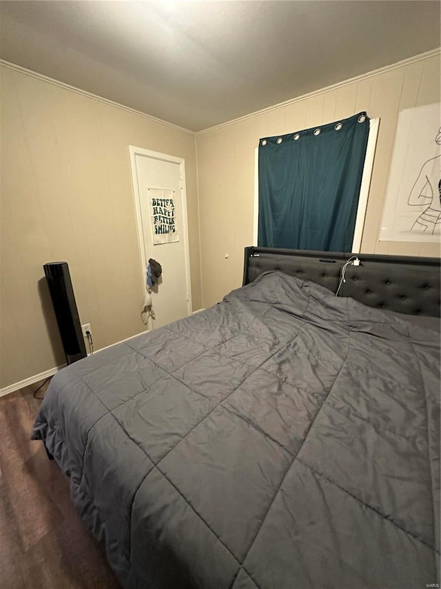 bedroom featuring wood-type flooring and crown molding