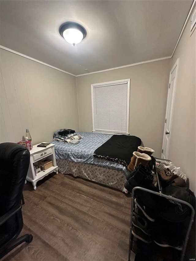 bedroom featuring hardwood / wood-style flooring and ornamental molding