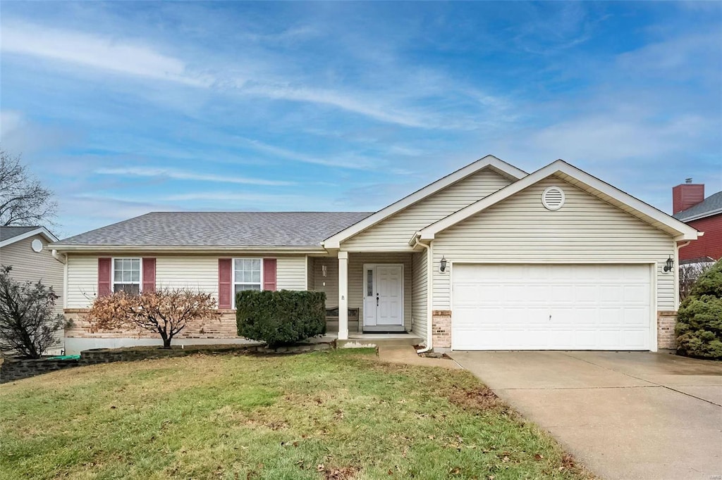 ranch-style home with a garage and a front yard