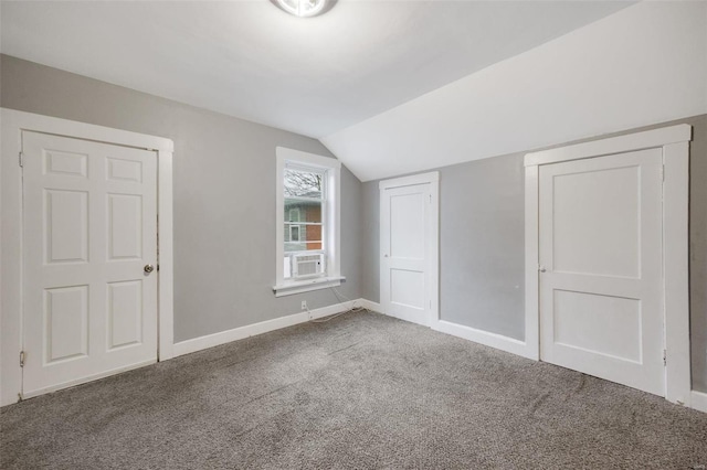 additional living space with cooling unit, lofted ceiling, and carpet floors