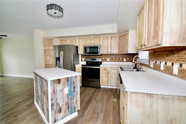 kitchen featuring sink, light brown cabinets, hardwood / wood-style floors, and appliances with stainless steel finishes