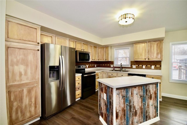 kitchen featuring a kitchen island, appliances with stainless steel finishes, dark hardwood / wood-style floors, sink, and light brown cabinets