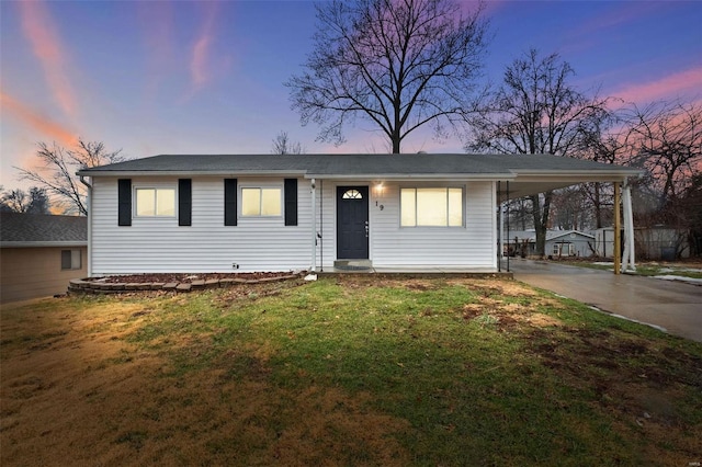 view of front of property with a yard and a carport