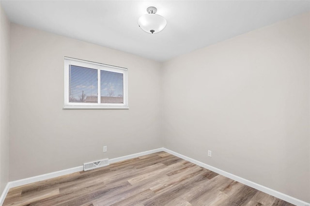 empty room with light hardwood / wood-style flooring