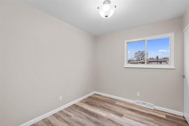 spare room featuring light wood-type flooring