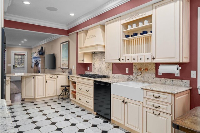 kitchen with custom exhaust hood, light stone counters, crown molding, stainless steel gas stovetop, and cream cabinets