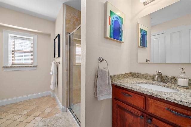 bathroom with vanity and a shower with door