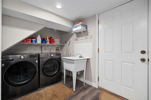 clothes washing area featuring dark hardwood / wood-style flooring and separate washer and dryer