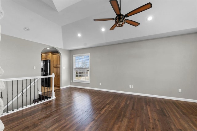 unfurnished room featuring dark wood-type flooring, ceiling fan, and high vaulted ceiling