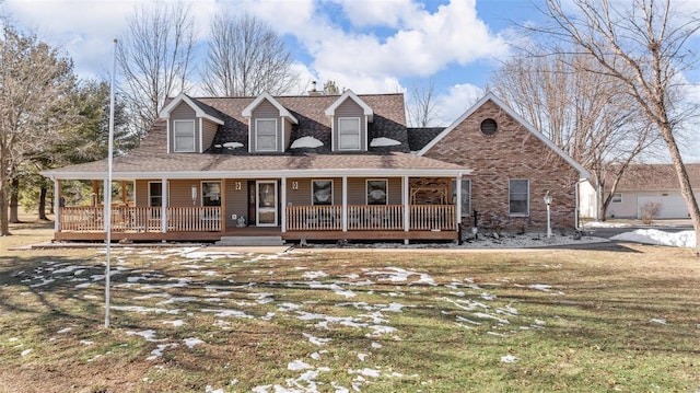 cape cod-style house featuring covered porch and a front yard