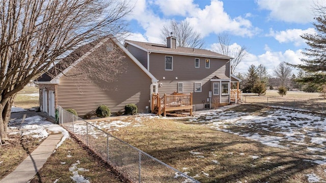 rear view of property featuring a deck