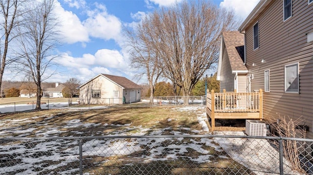 snowy yard featuring a wooden deck and central air condition unit