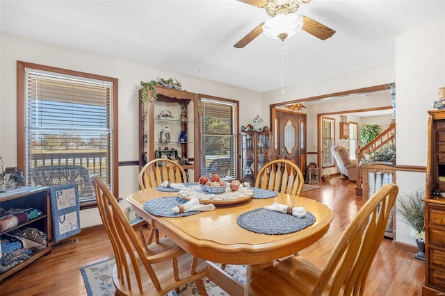 dining room with ceiling fan and light wood-type flooring