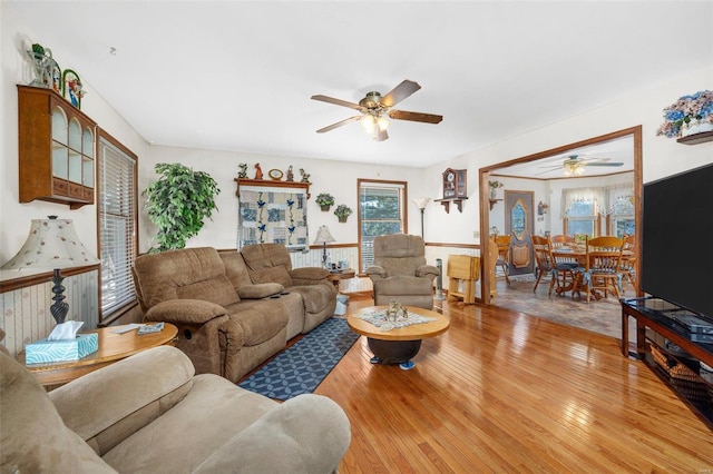 living room featuring ceiling fan and light wood-type flooring