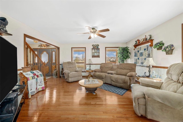 living room featuring light hardwood / wood-style flooring and ceiling fan