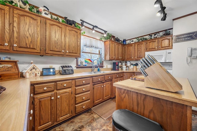 kitchen with rail lighting and sink