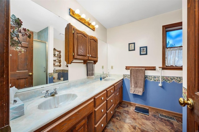 bathroom with vanity, a shower with shower door, and toilet