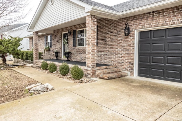 entrance to property with a garage and covered porch