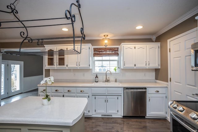 kitchen featuring white cabinetry, sink, ornamental molding, and stainless steel appliances