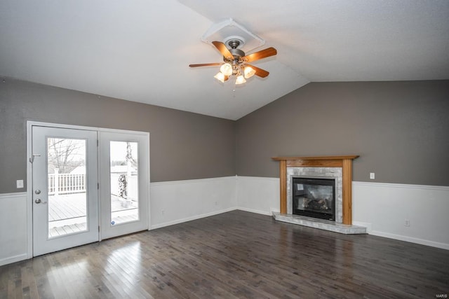 unfurnished living room with ceiling fan, a fireplace, lofted ceiling, and dark hardwood / wood-style floors