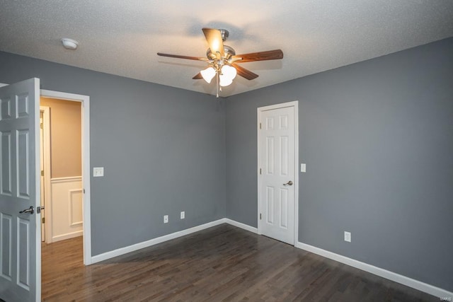 unfurnished room featuring dark hardwood / wood-style floors, a textured ceiling, and ceiling fan