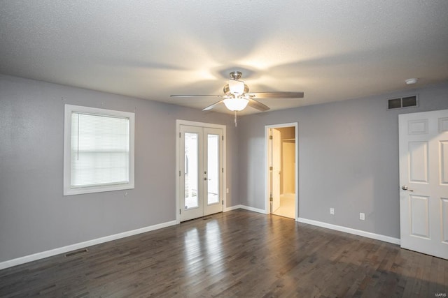 spare room featuring dark hardwood / wood-style flooring, a textured ceiling, french doors, and ceiling fan