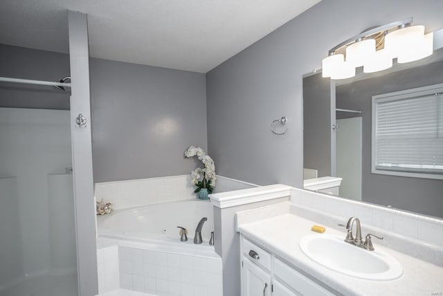 bathroom with independent shower and bath and vanity