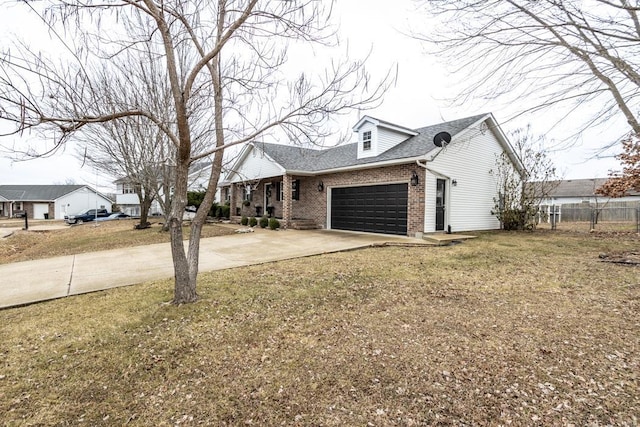 view of front of property featuring a garage and a front lawn