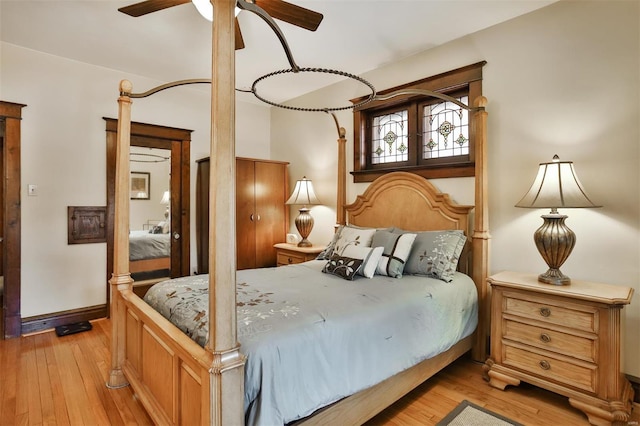 bedroom featuring light wood-style floors and baseboards