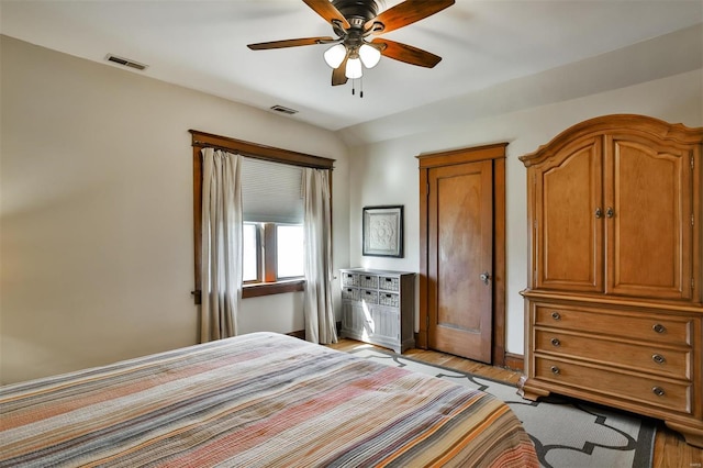 bedroom with visible vents, ceiling fan, and light wood finished floors