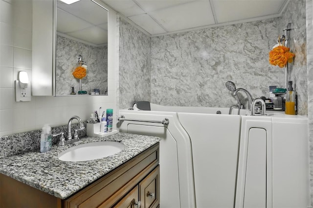 full bathroom with a bath and vanity